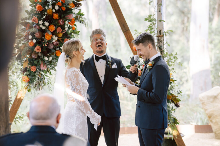 Paul Wheeler laughing with a wedding couple during a relaxed Sydney ceremony